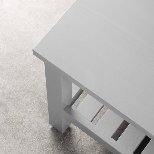 Minimalist bench crafted from smooth, light-colored wood with sleek, clean lines and a spacious shelf beneath for storage.