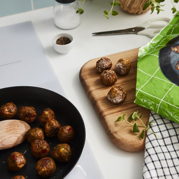 Image shows open package of HUVUDROLL vegetable balls, revealing cooked, round balls with visible veggies on a wooden cutting board.