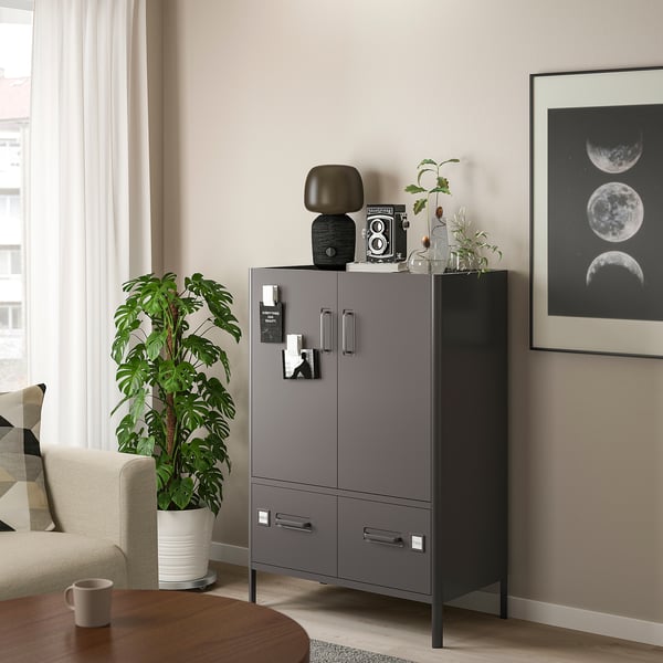 Modern living room with IDÅSEN grey cabinet, white plant, and moon wall art.