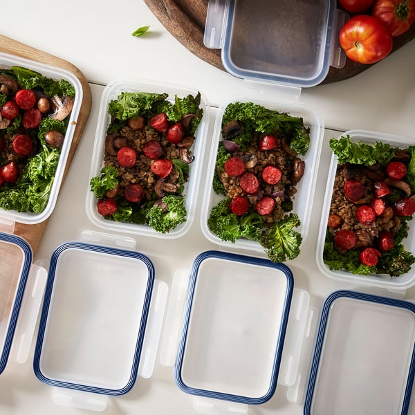 Several rectangular containers with lids hold cooked meals, showcasing their stackability and functionality for food storage and leftovers.