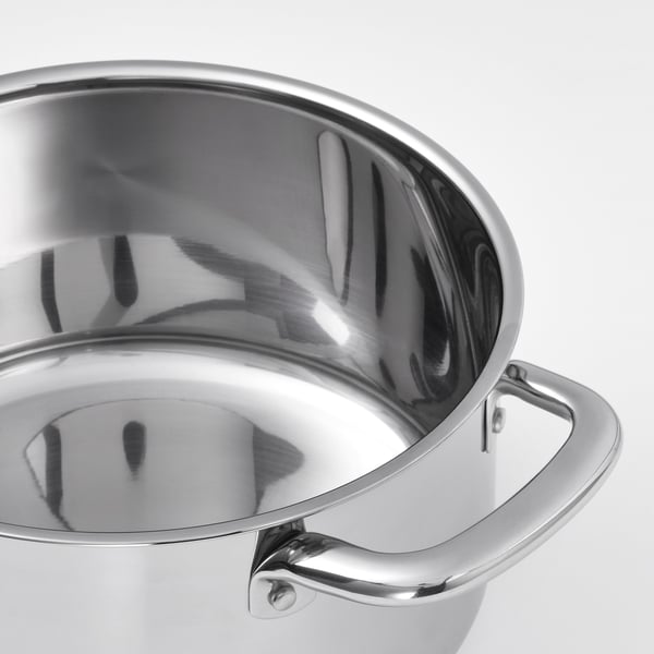 Polished stainless steel saucepan with sturdy handles reflecting light, showcasing sleek design and quality finish.