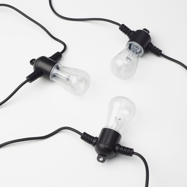 Three hanging string lights with clear bulbs and black sockets.