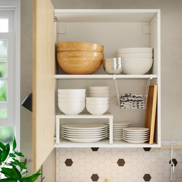 Kitchen cabinet with organised dishes and utensils.