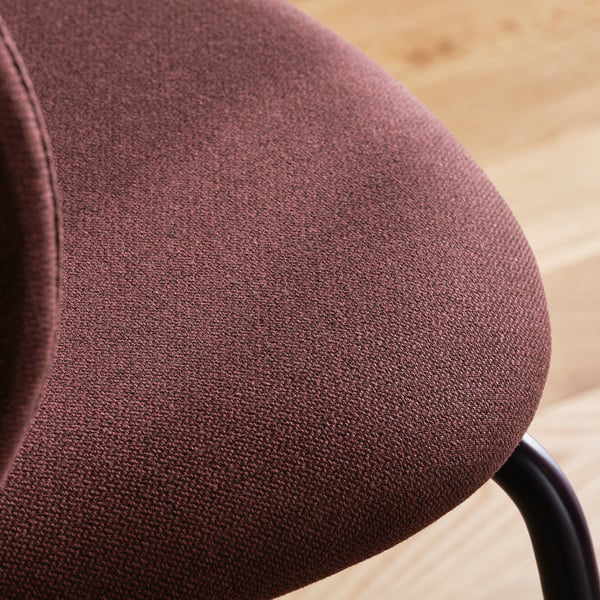 Close-up of an upholstered chair with dark brown fabric and a metal base, showcasing its comfort and quality.