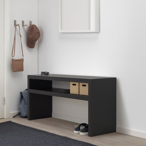 BLACK LACK console table with open storage, fitting neatly under wall hooks with hanging items.