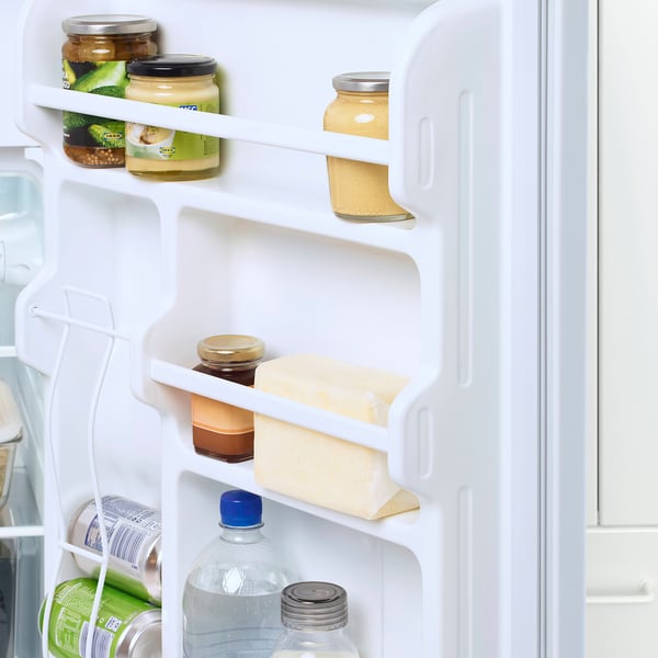 Fridge door with adjustable shelves holding jars and cartons.