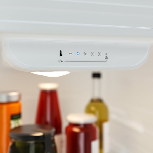 Digital fridge panel with settings, including temperature and led light controls, displayed above kitchen items.