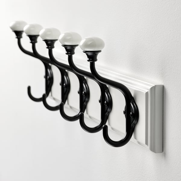 Elegant black coat rack with 5 porcelain knobs, sturdy design for hanging.