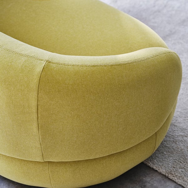 Modern green upholstered chair, soft curves, quality fabric, elegant design