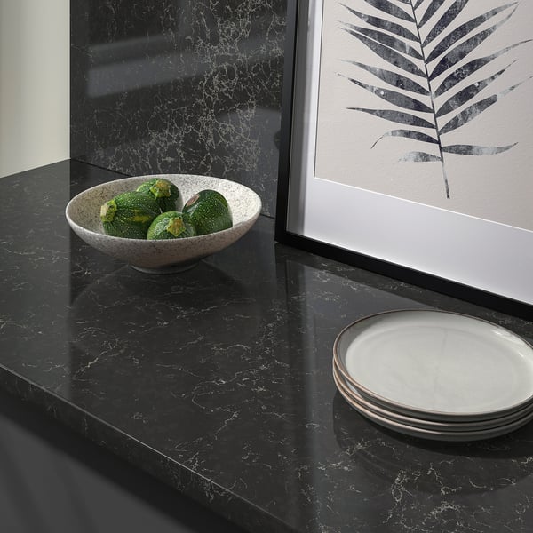A sleek kitchen countertop made of recycled glass with avocados in a bowl, showing its stain-resistant surface.