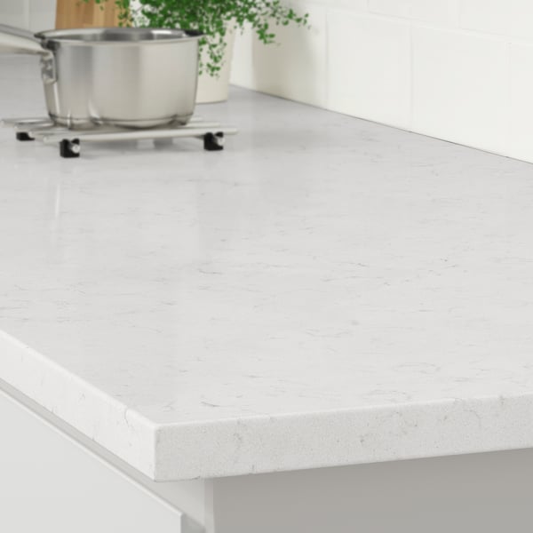 A sleek white kitchen countertop made of recycled glass, showcasing its durable, stain-resistant, and easy-to-clean surface.