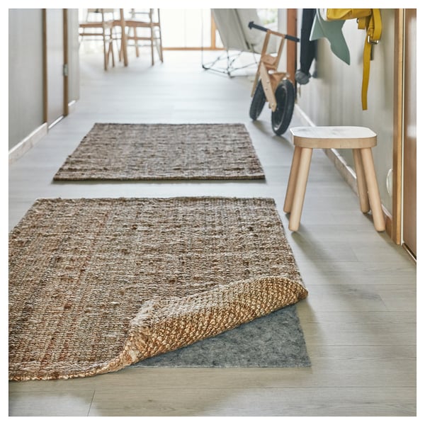 LOHALS brown jute rugs in a hallway, providing a natural, warm look with a practical design.