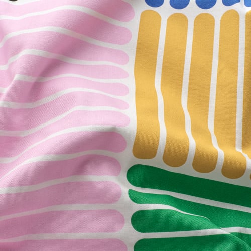 Vibrant fabric close-up with wavy pink, yellow, and green stripes. High-quality cotton texture detailed.