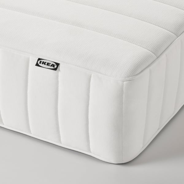Close-up of a white ikea mattress corner, showcasing its quality texture and design.