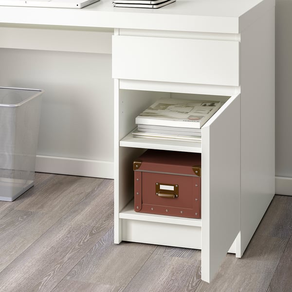 White MALM desk with shelves storing books and a box, showcasing cable management and versatile storage.