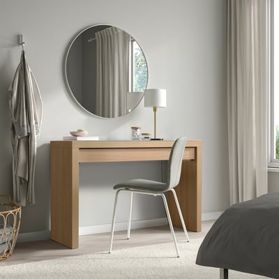 Modern office with MALM desk, chair, lamp, mirror, and bed. Large window with curtains, hanger with garment.