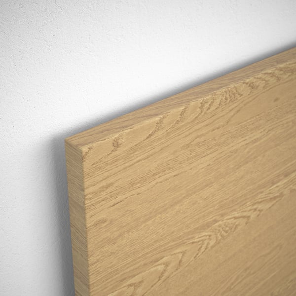 Close-up of a wooden bed surface, showing natural grain and smooth finish.