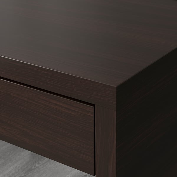 Modern dark wood desk with sleek edges & cable management hole at back, showcasing quality craftsmanship.