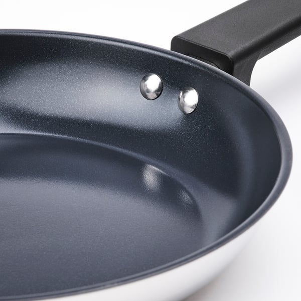 Close-up of high-quality, non-stick frying pan with durable, black handle and smooth interior surface.