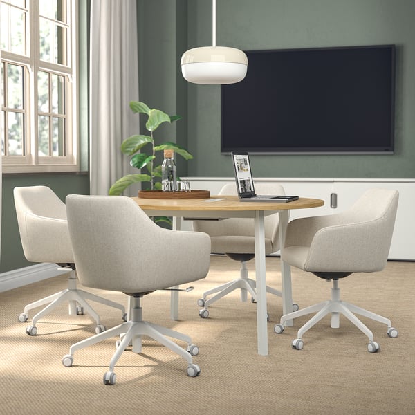 Small round meeting table, MITTZON, beech top & white base, 4 light grey chairs, green wall, large tv.
