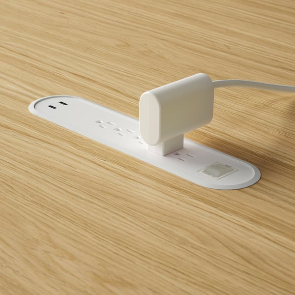 White usb charging stations integrated into wooden table, suitable for small group meetings.