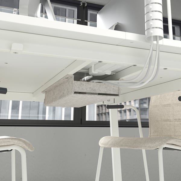 Modern conference table with cable management, supporting multiple chairs.