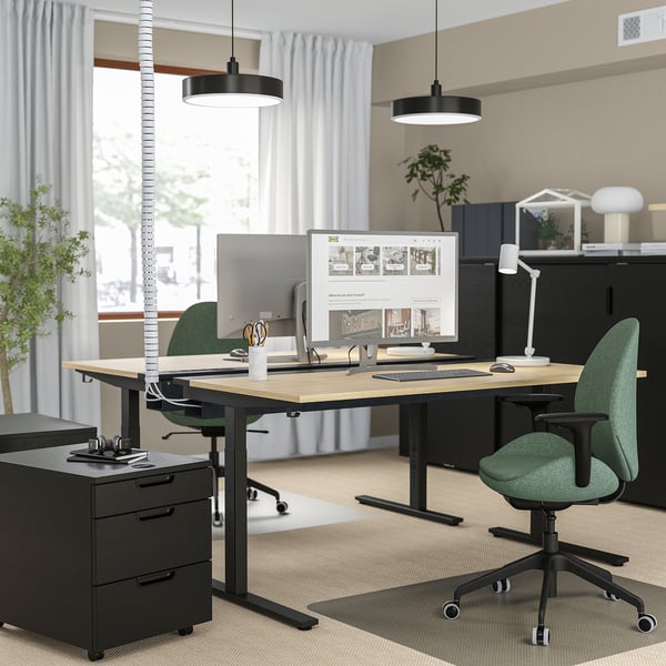 Modern office with MITTZON desks, green chairs, black cabinets, and pendant lights.