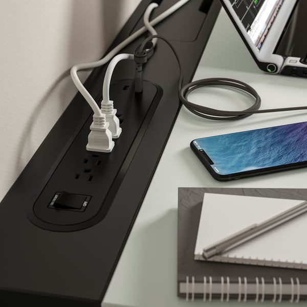 Desk with tech, pen, neat cables - perfect home office.