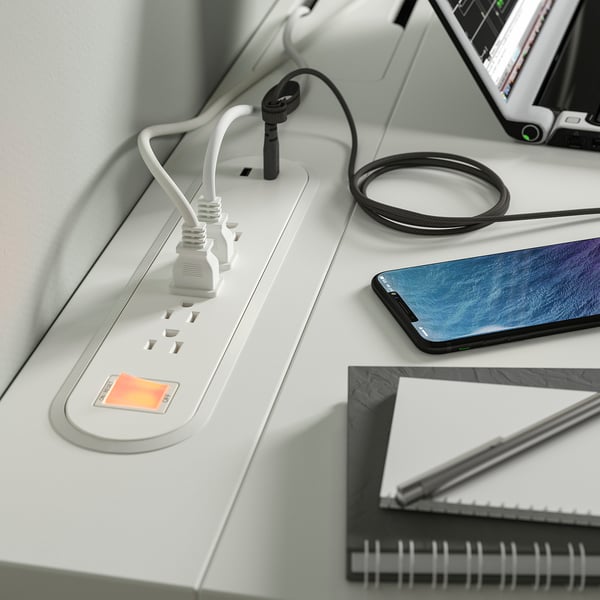 Desk with devices and cables.