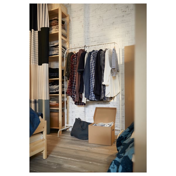 Wooden floor room, MULIG rack with clothes, box, bag, partial bed.