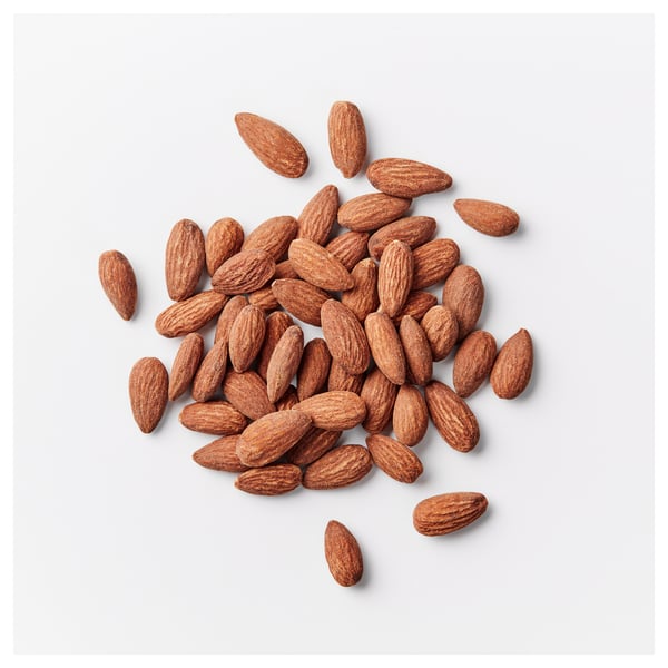 Scattered almonds on a white surface. Key ingredients shown: almonds.