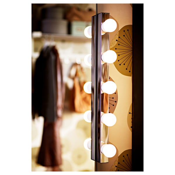 Vertical wall lamp with illuminated bulbs, resembling a pearl necklace, providing bright, diffused light, ideal for bedroom or hallway.