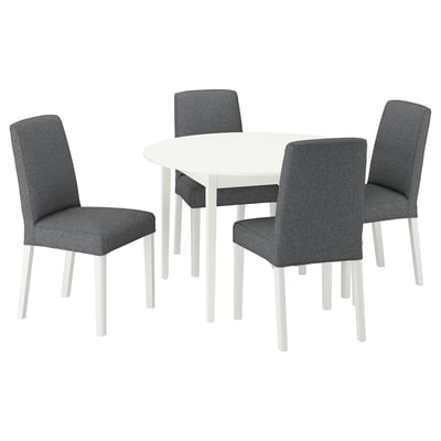 A white round dining table with four grey upholstered chairs, modern design.
