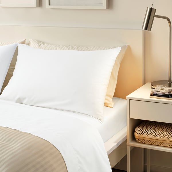NATTJASMIN white bed set. Crisp white with smooth, silky feel. Large bed matches walls neutral tones.