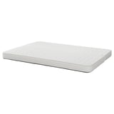 White rectangular sofa-bed mattress by IKEA, featuring a textured surface and firm support.