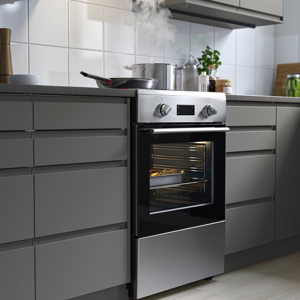 Modern kitchen with ÖRMINGE oven and sleek cabinets.