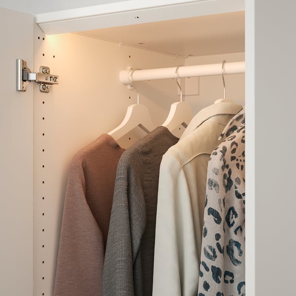Lit wardrobe with led strips, coats neatly hung, lights on when door opens. Or wardrobe with led strip lights, coats hung, lights auto-on.