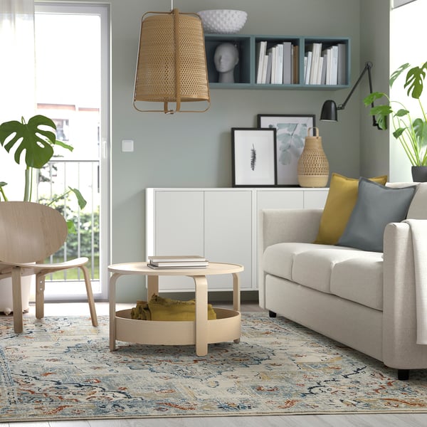 ONSEVIG rug in modern living room with grey sofa and wooden chair.