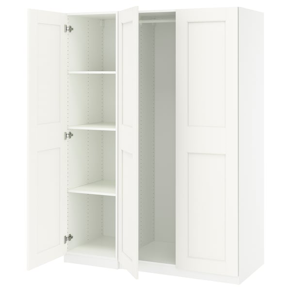 A white IKEA PAX wardrobe with open doors. It has adjustable feet and hinges with soft closing mechanisms.