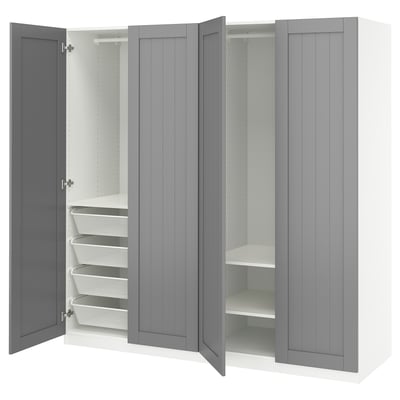 A grey PAX wardrobe with open doors revealing shelves and mesh drawers.