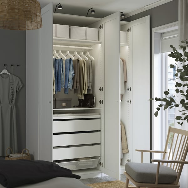 Modern bedroom wardrobe with drawers, shelves, and hangers.