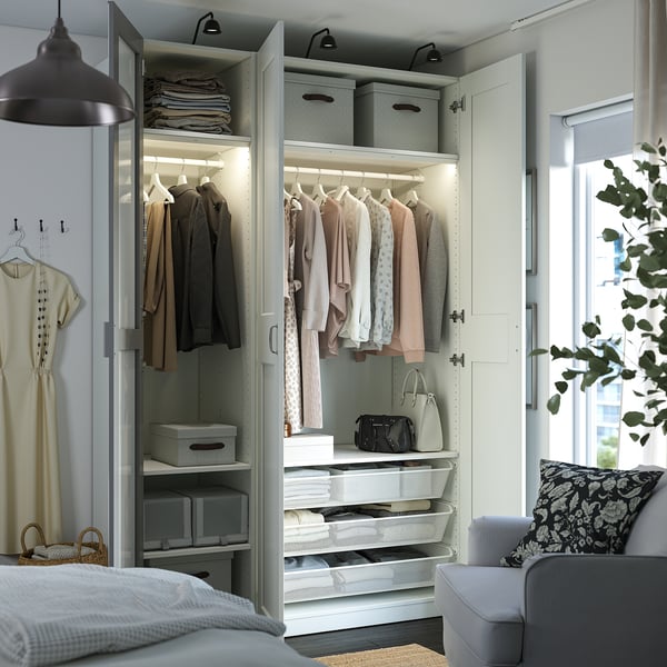 Open wardrobe with clothes, accessories, and lights. Wardrobe shelves, drawers, and hanging space.