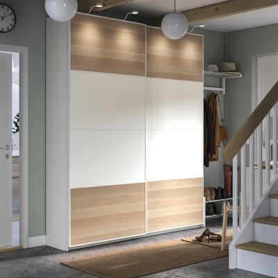 Modern entryway with PAX wardrobe; light wood and white tones, sliding doors, organised accessories.