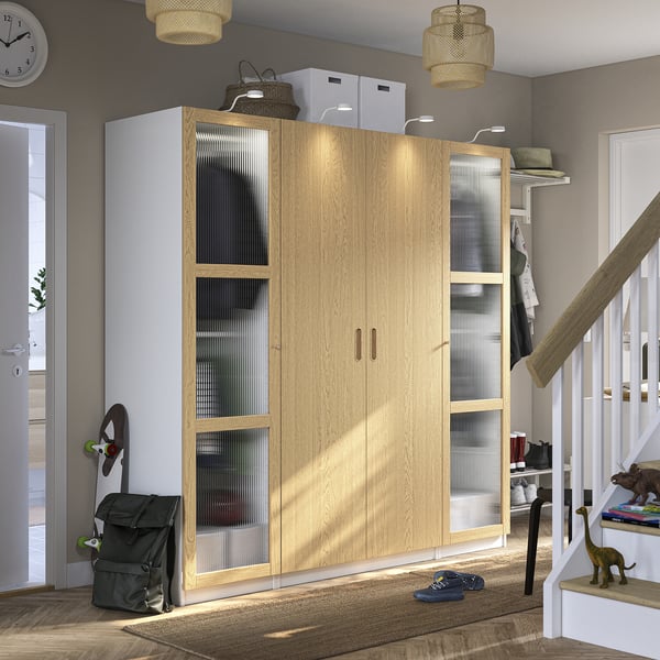 PAX wardrobe with glass doors stores pushchair, backpack, fits perfectly in hallway.