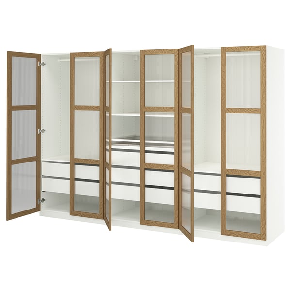 White PAX wardrobe with oak trim, glass doors open, showing shelves.