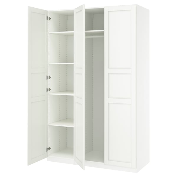 White ikea PAX wardrobe with open doors, showing empty shelves.