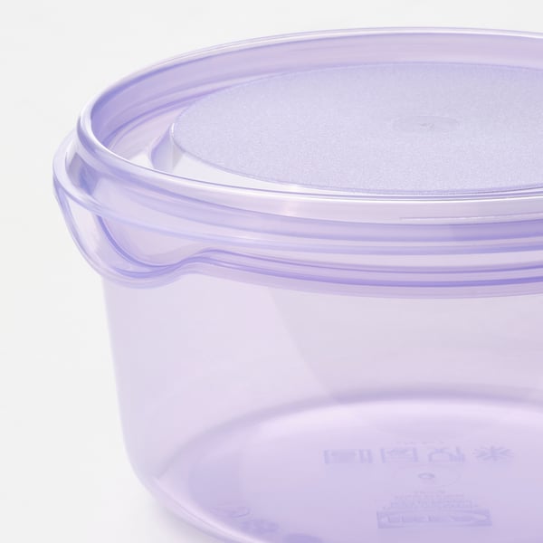 Round, semi-transparent, violet plastic container with a secure lid.
