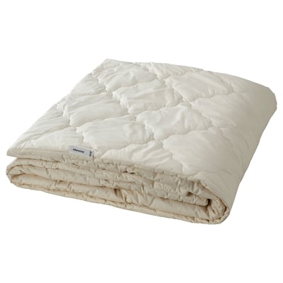 Folded white wool comforter. Natural and breathable, ideal for all seasons. Rectangular and neatly folded, pure white colour.