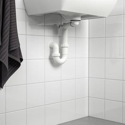 A sink water trap installed inside a cabinet, allowing space for a drawer. Its part of the RÄNNILEN system.