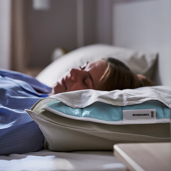 Person sleeping with REXBEGONIA cooling pillow pad.